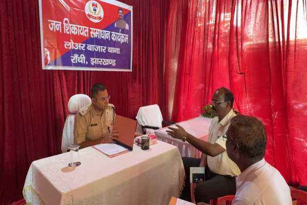 जन-शिकायत समाधान कार्यक्रम के दौरान लोगों की समस्याएं सुनते पुलिस अधिकारी