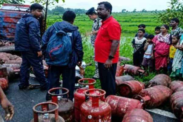 Cylinder-laden truck overturns