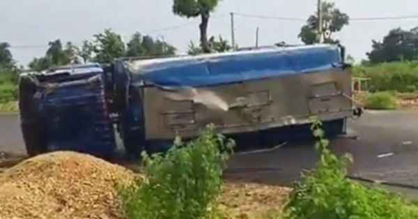 Diesel tanker overturns after going out of control on the Chaibasa-Chakradharpur route; villagers carry away diesel in vessels.